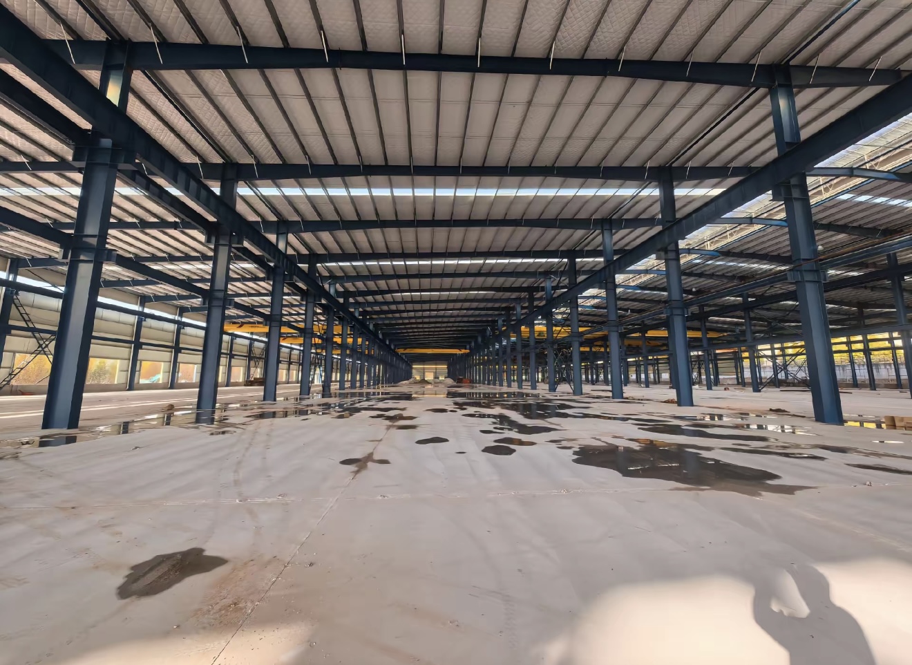 Interior frame photos show span, column layout and installed steel member coordination. for Korea steel structure buyers