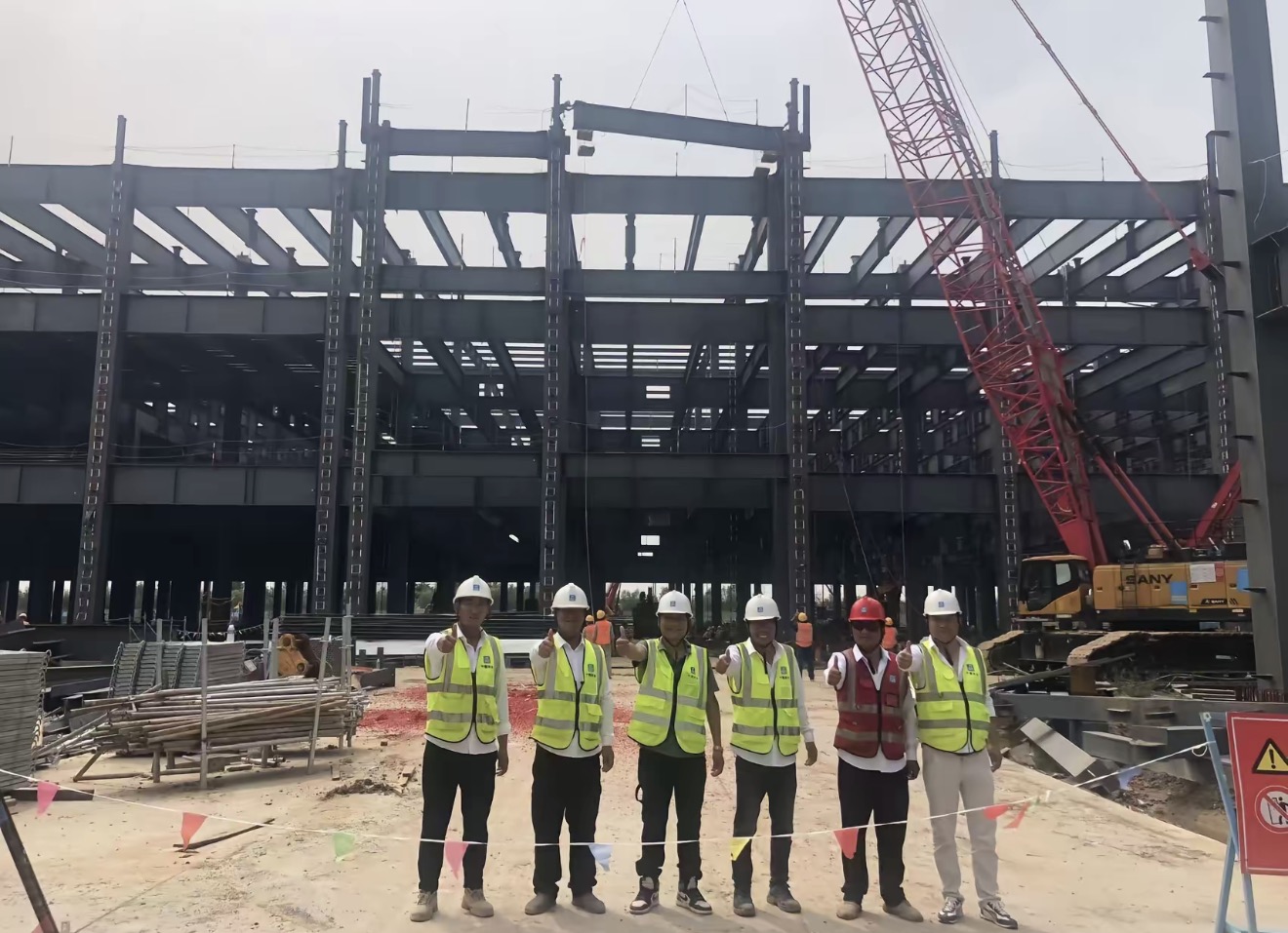 Korea steel frame erection site inspection with project team and crane lifting work