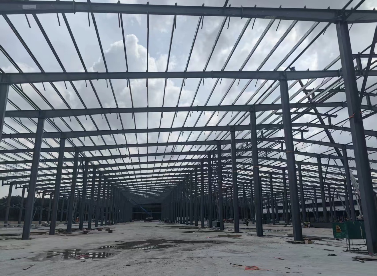 Malaysia warehouse steel frame progress with columns beams and roof purlins