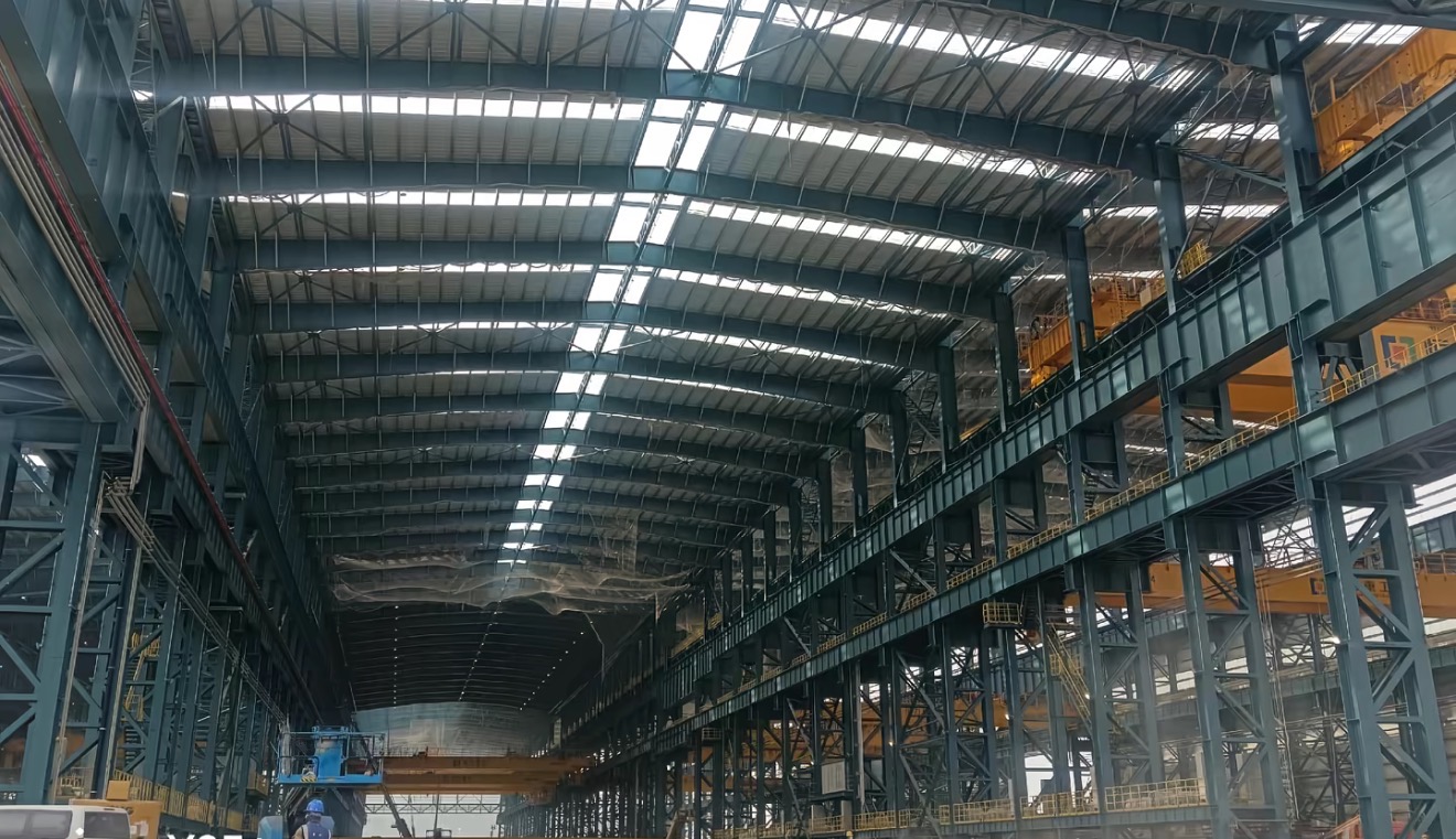 Large shipyard workshop interior steel structure with overhead crane beams